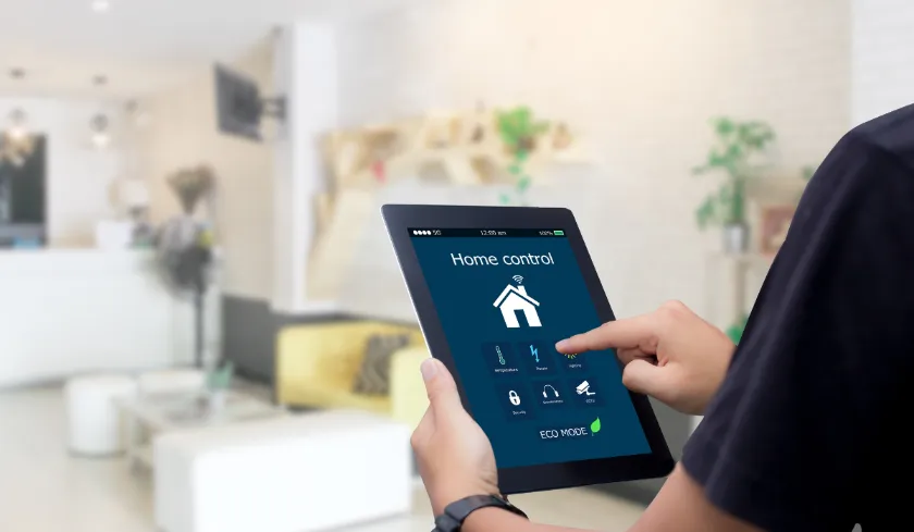 Person using tablet to control home lighting with smart app