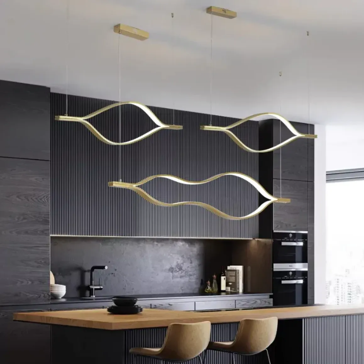 Modern kitchen with gold wave pendant lights, adding luxury and style to a contemporary interior.