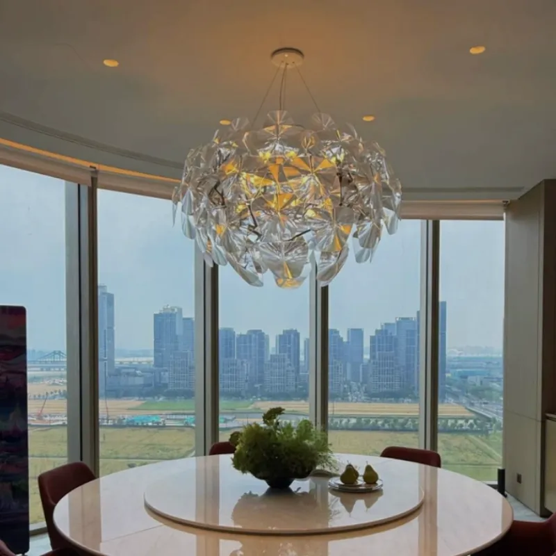 Modern pendant light hanging above a dining table, creating a warm and stylish dining space.