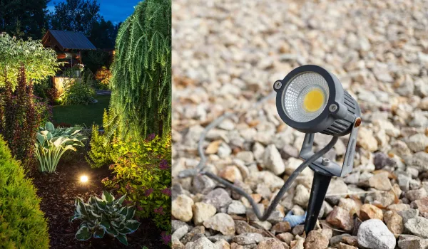 Garden spotlight placed among rocks and plants for landscape lighting