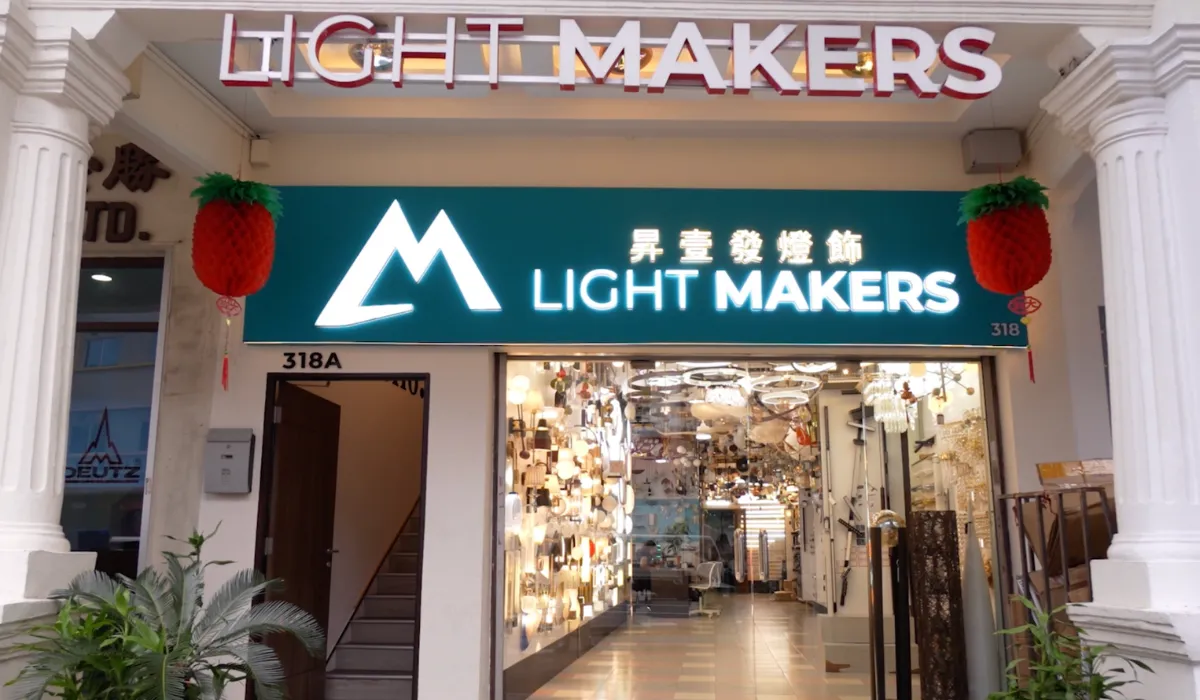 The illuminated storefront of Light Makers, showcasing various lighting fixtures.
