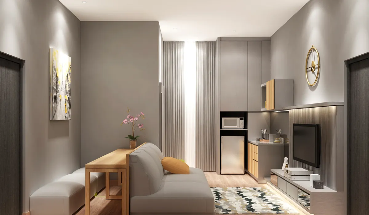 Bright, spacious open-concept living and dining area with layered lighting, grey sofa, and minimalist kitchen design.