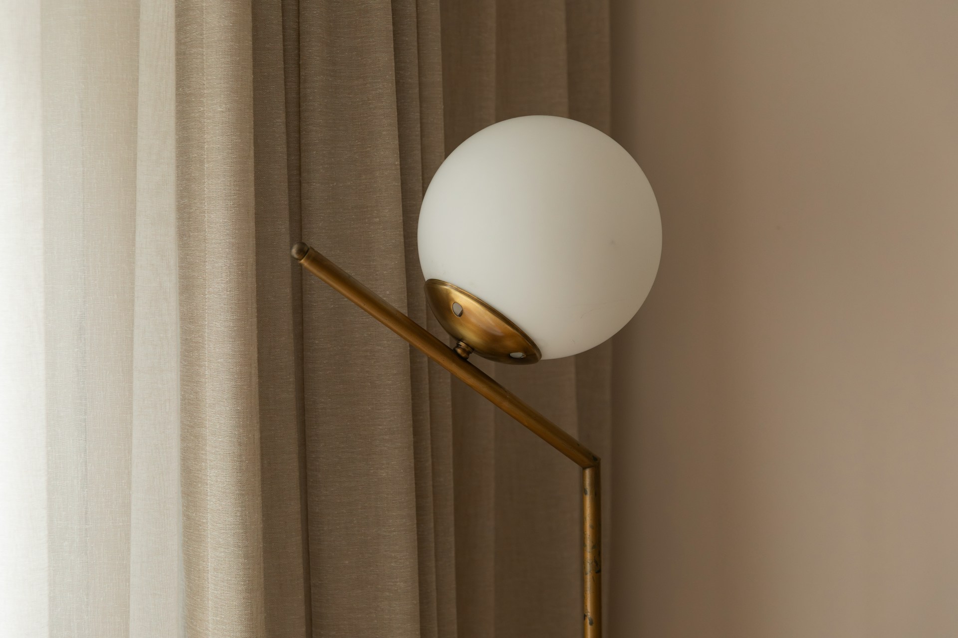 Modern floor lamp softly illuminating a cozy living room with warm ambient lighting and neutral decor