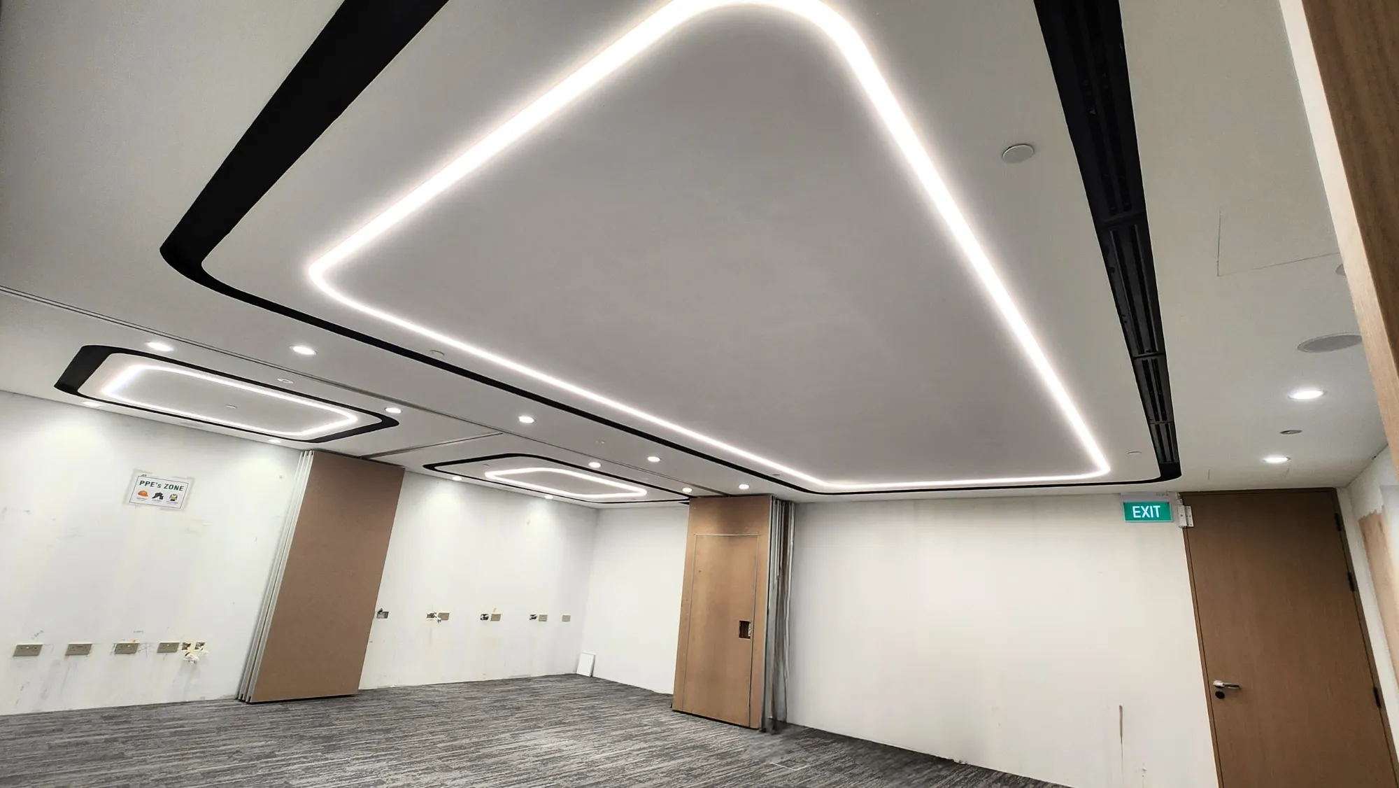 Ceiling-integrated LED lighting in a modern conference or meeting room under construction.
