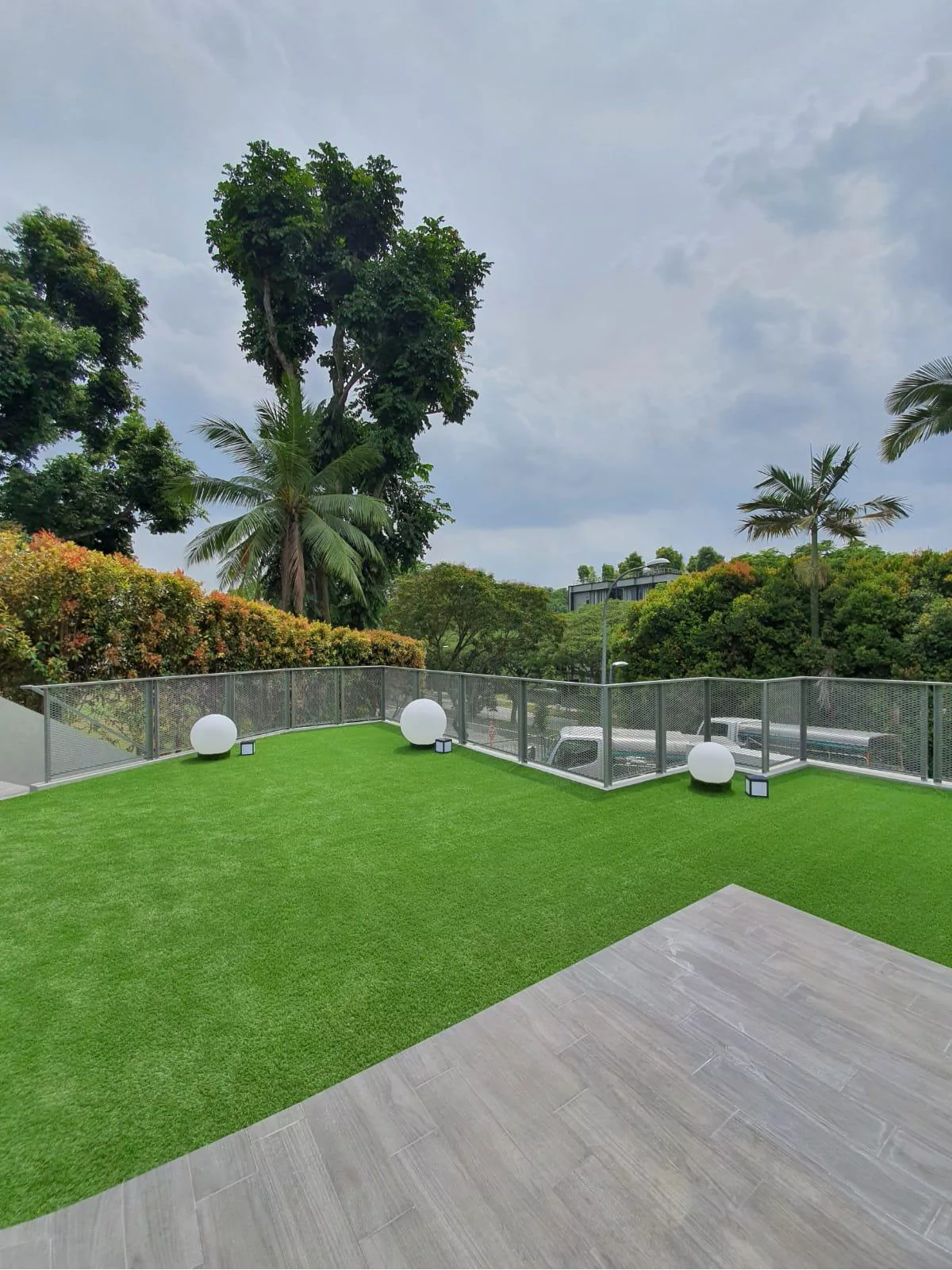 {"default":"Lush outdoor terrace enhanced with modern LED globe lights scattered across the green artificial grass, creating a vibrant and inviting ambiance. "}