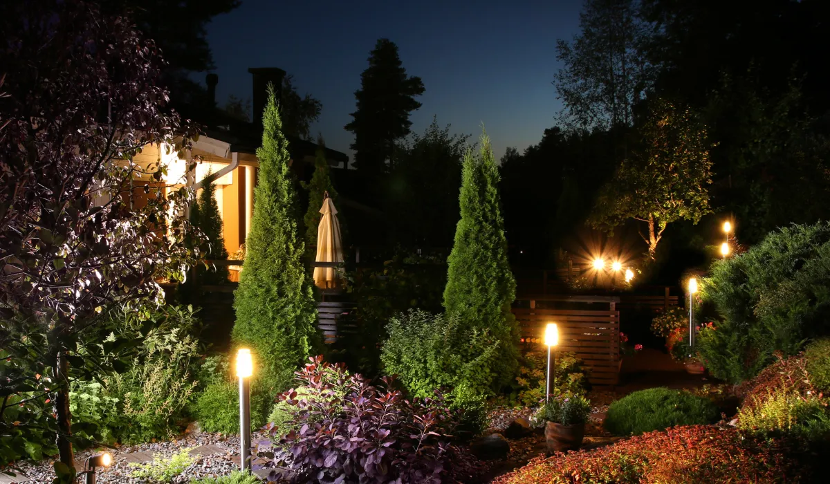 Beautifully lit garden with outdoor pathway lights at night