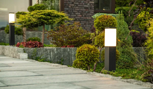 Modern bollard lights lining a garden walkway at dusk