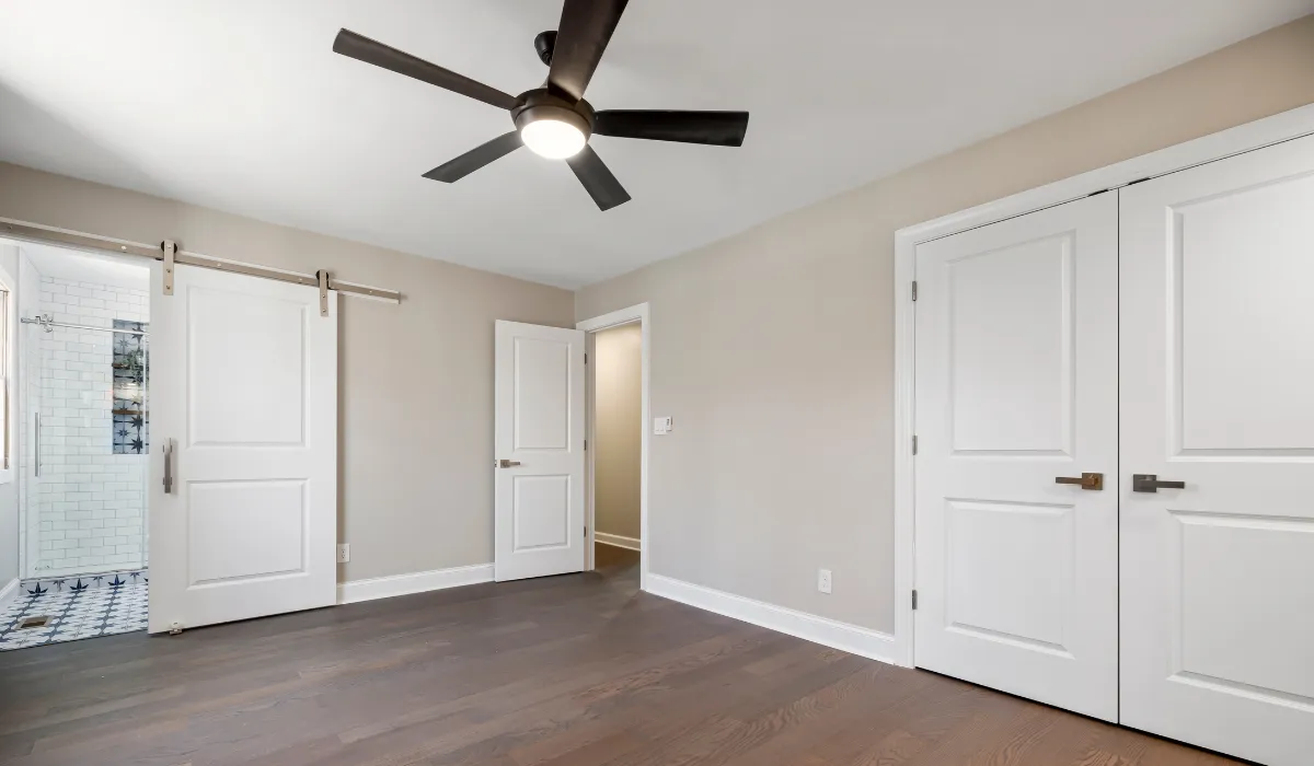 Black smart ceiling fan with integrated light in a vaulted room ceiling