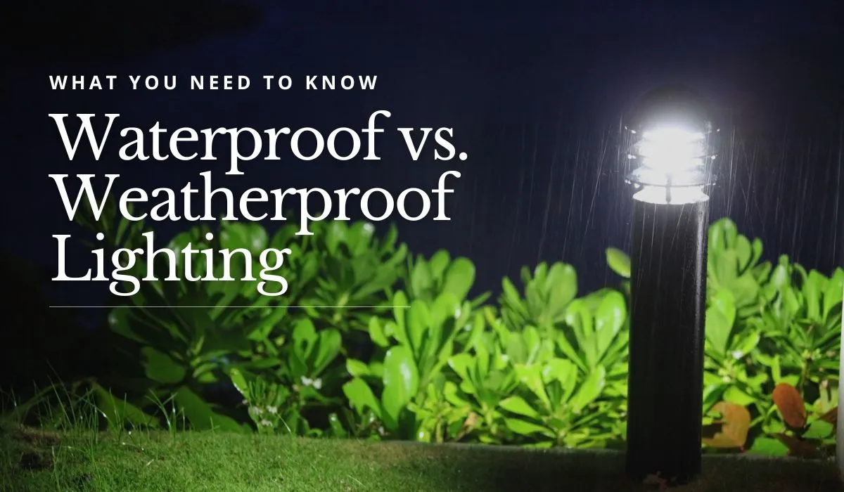Outdoor light post shining in the rain next to green bushes at night