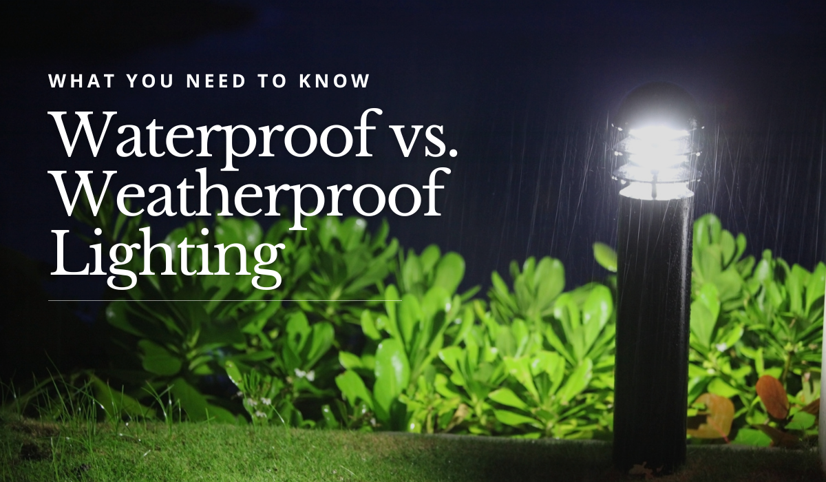 Waterproof outdoor light post shining in the rain next to green bushes at night