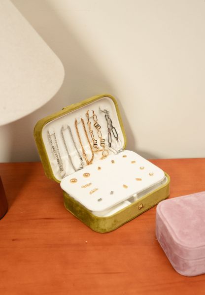 Minimal travel jewellery box with soft compartments for necklaces, earrings and charms