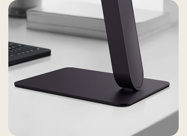 Close-up view of LG UltraGear monitor stand on a modern desk.