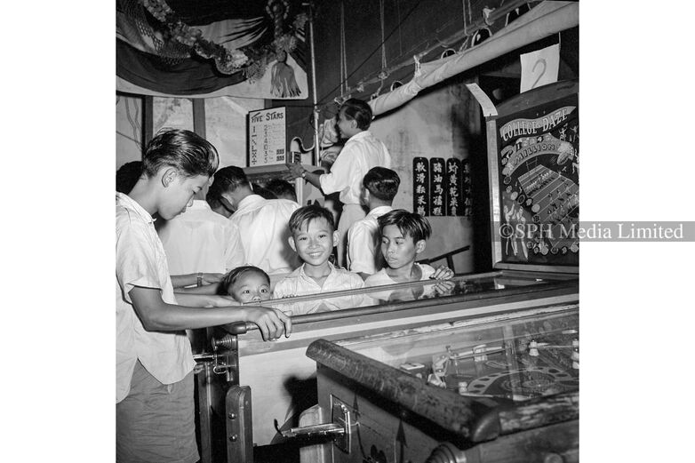 Kids playing the pinball machine, 1955 Print