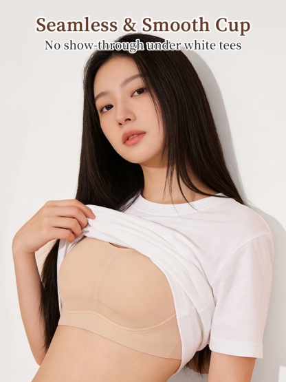 Beige seamless smooth-cup minimizing bra shown under a white T-shirt, VEIMIA