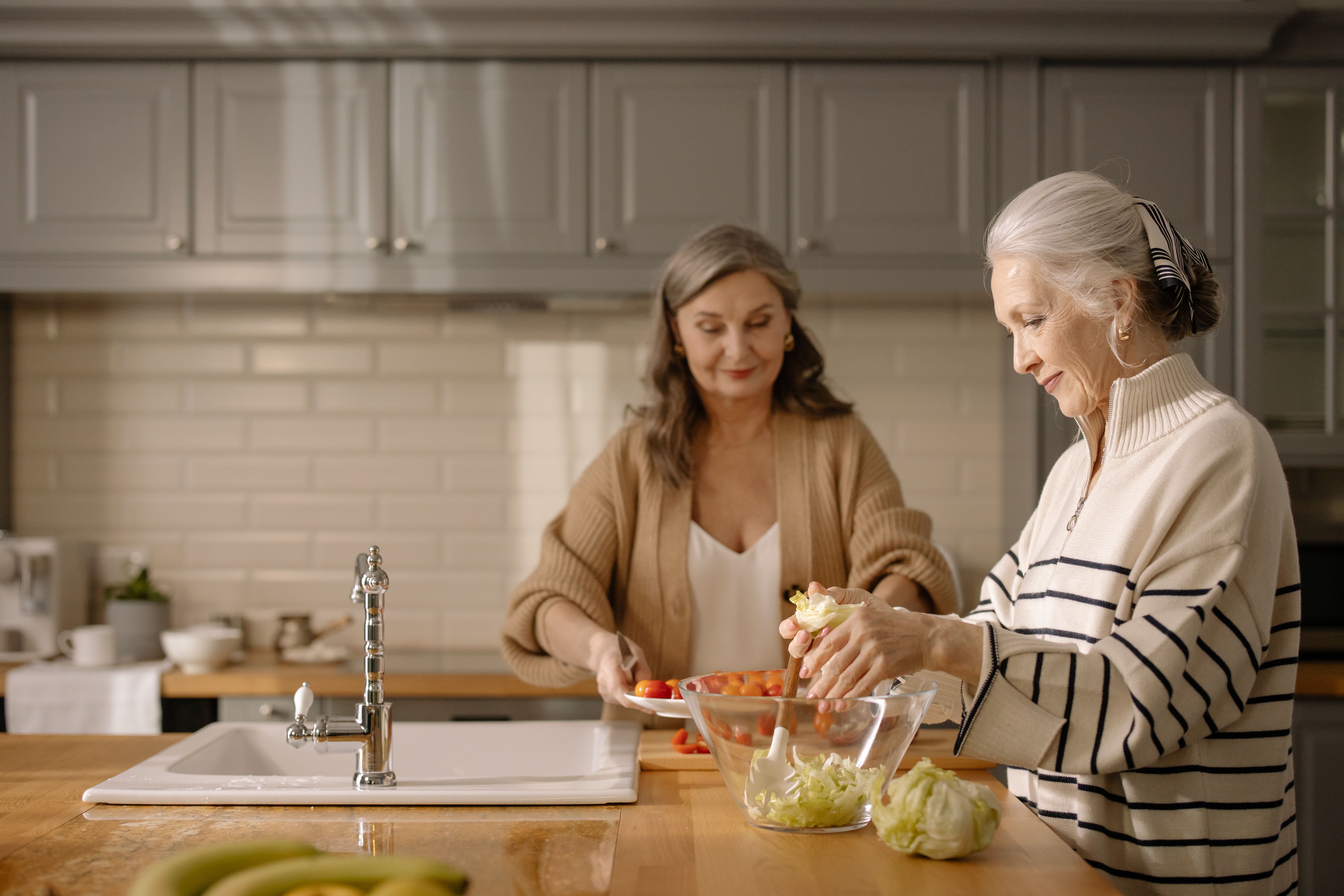 VEIMIA two women preparing food together during everyday life after breast cancer surgery