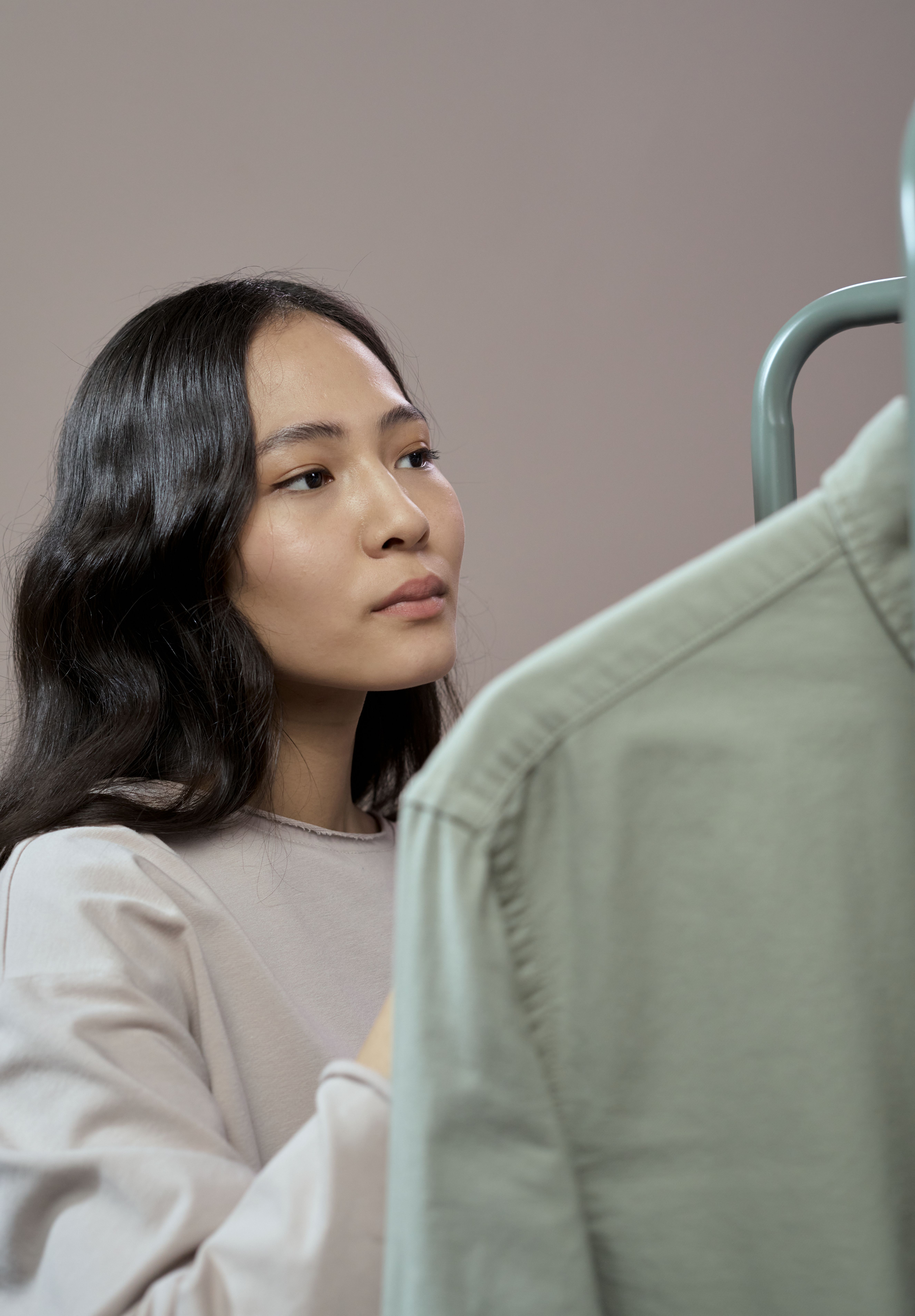 VEIMIA Asian woman choosing simple layered clothing after mastectomy