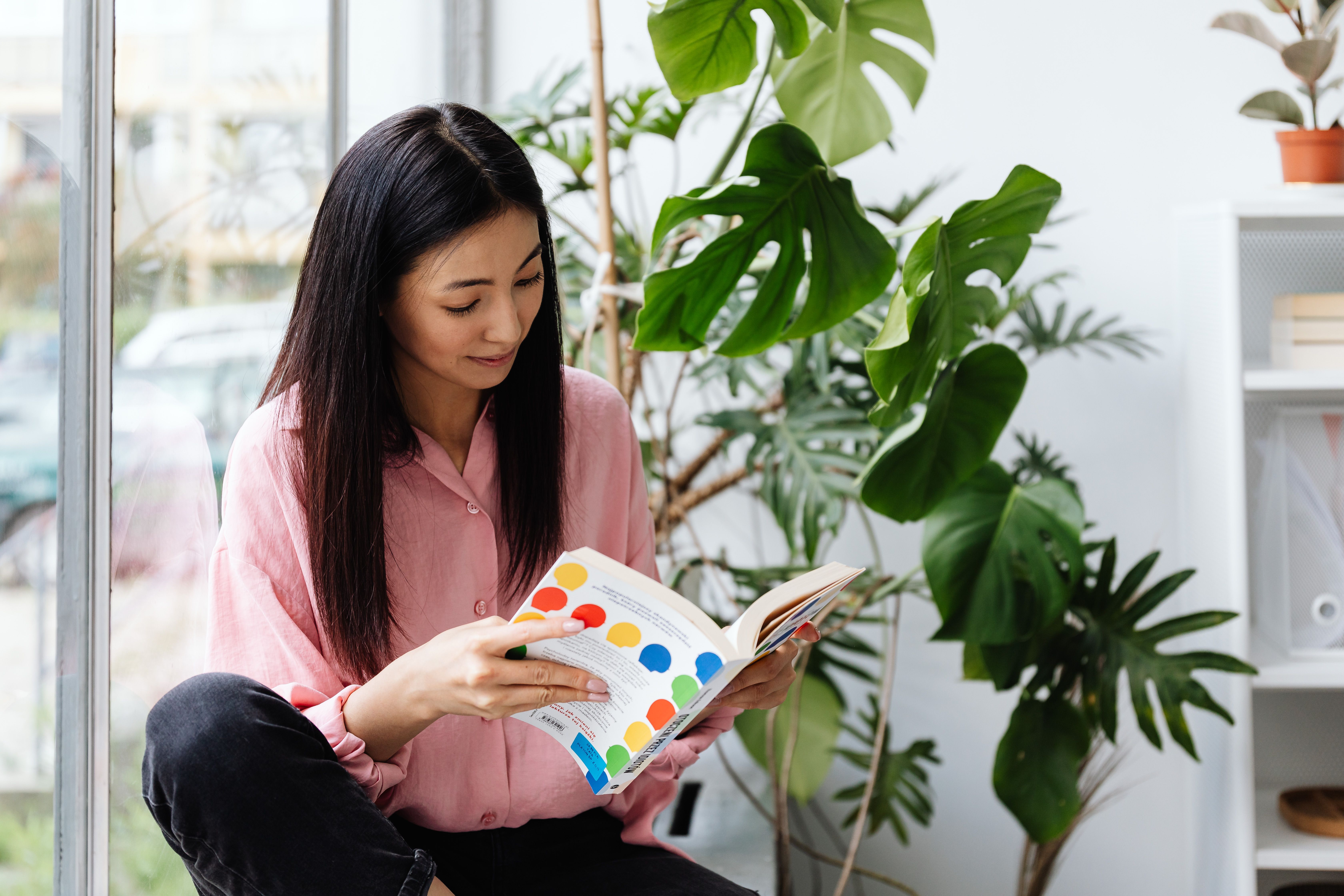 VEIMIA Asian woman in a soft pink shirt enjoying an ordinary day at home after breast surgery