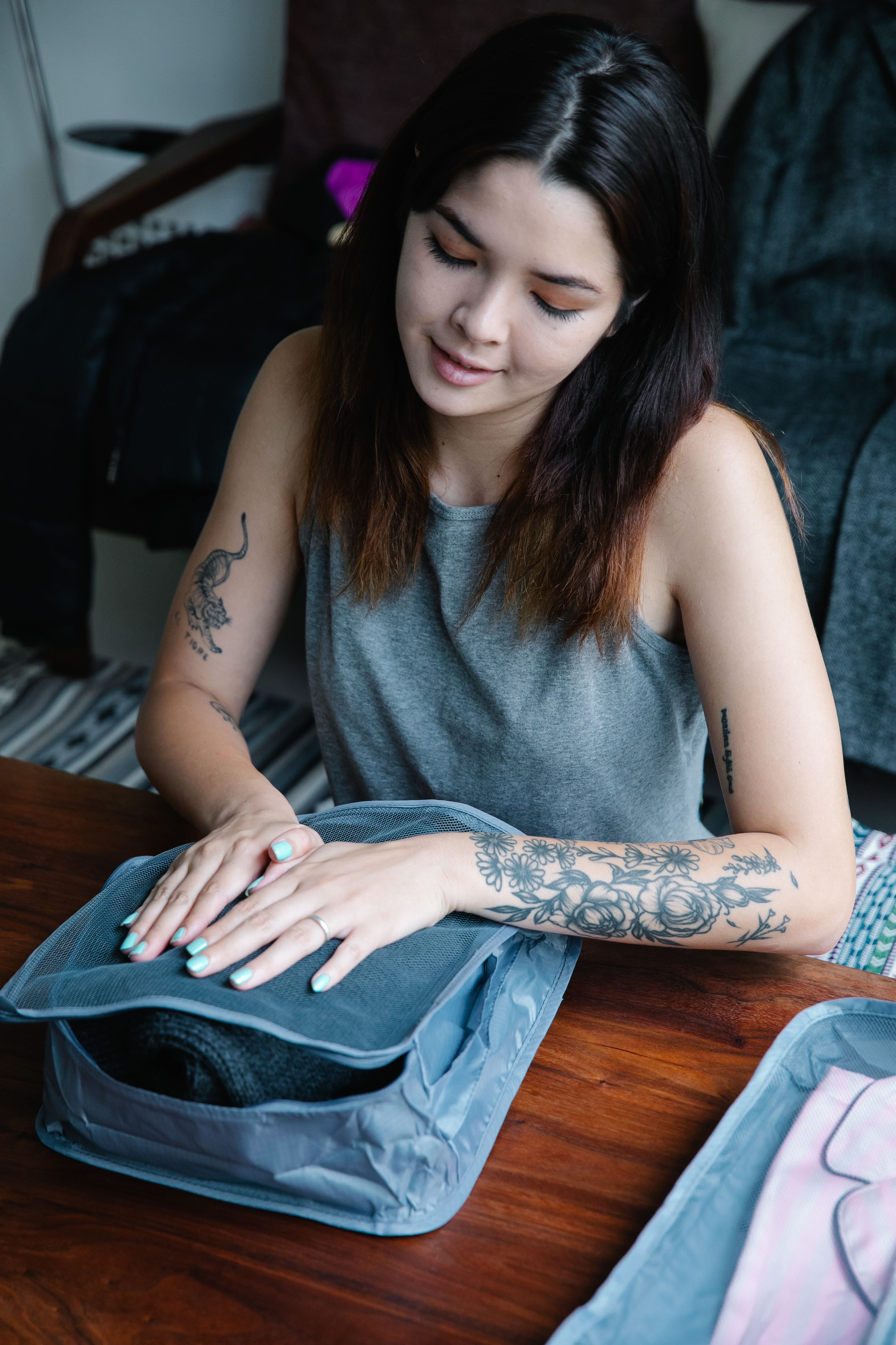 VEIMIA Asian woman packing comfortable clothes for travel after mastectomy