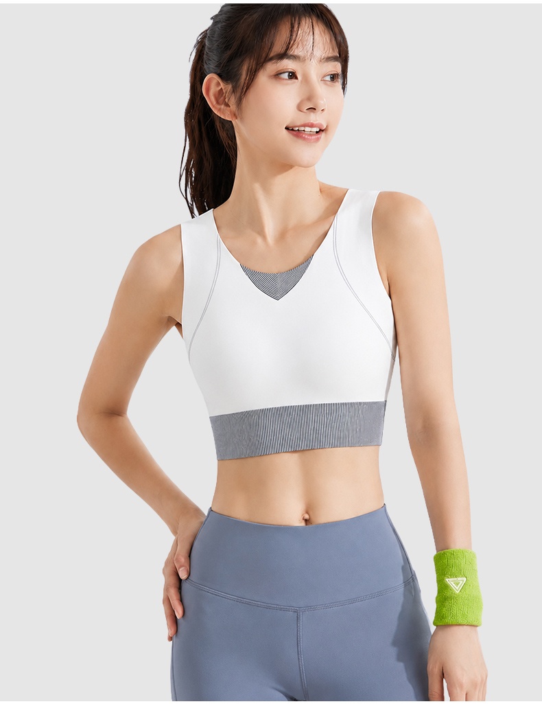 Model wearing white sports bra front view with grey ribbed hem VEIMIA