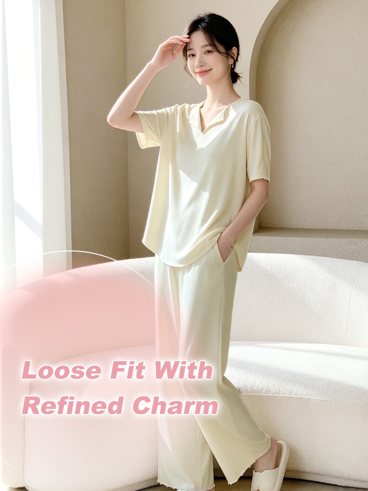 Full-body model wearing a light yellow loose-fit pajama set beside a sofa - VEIMIA