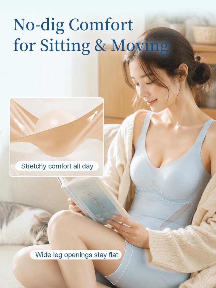 Seated model wearing light blue shaping bodysuit with wide leg openings VEIMIA