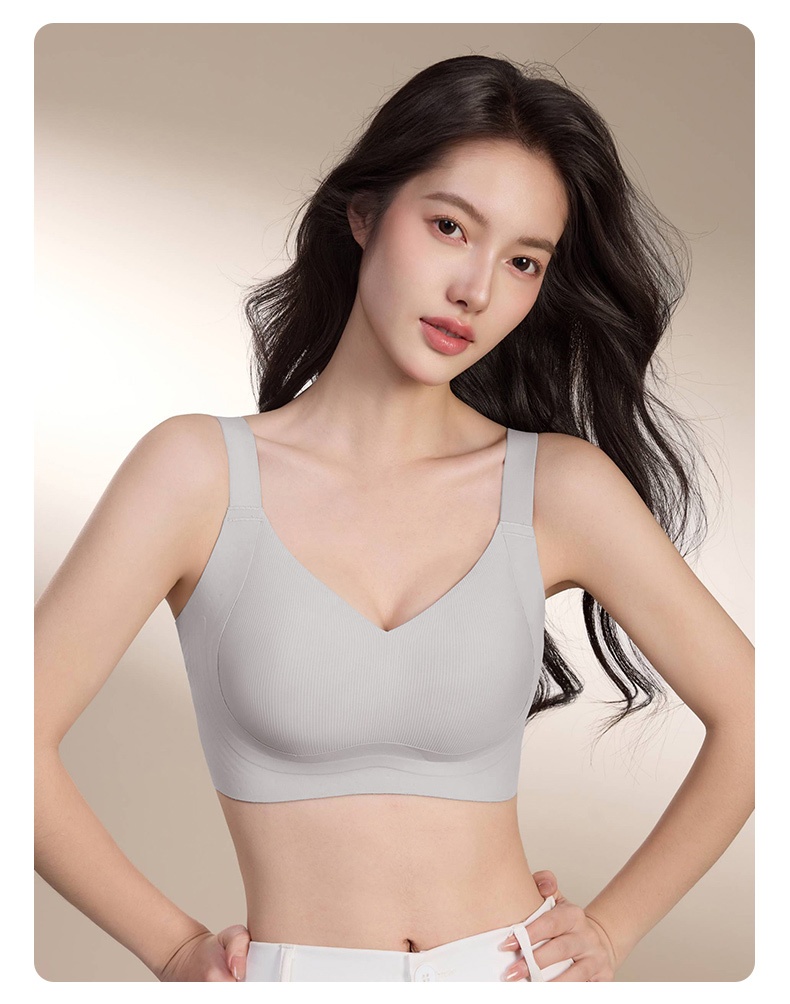Model wearing light blue V neckline bra with broad straps and underbust support band VEIMIA