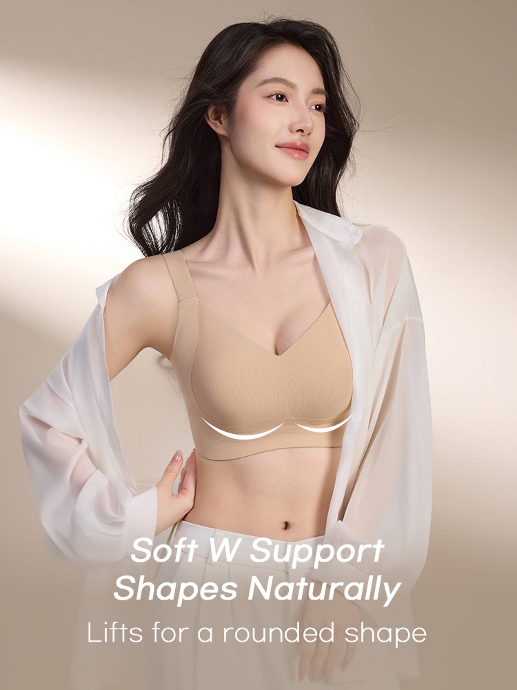 Model wearing beige supportive bra beneath an open white shirt with underbust lift graphic VEIMIA