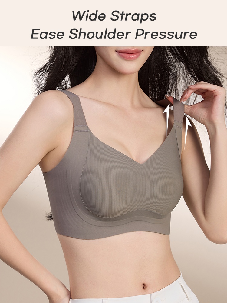 Model wearing gray full coverage bra while lifting one wide shoulder strap VEIMIA