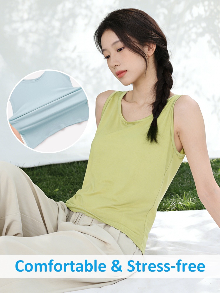 Green loose tank top on seated model with soft stretchy fabric and comfortable feel - VEIMIA