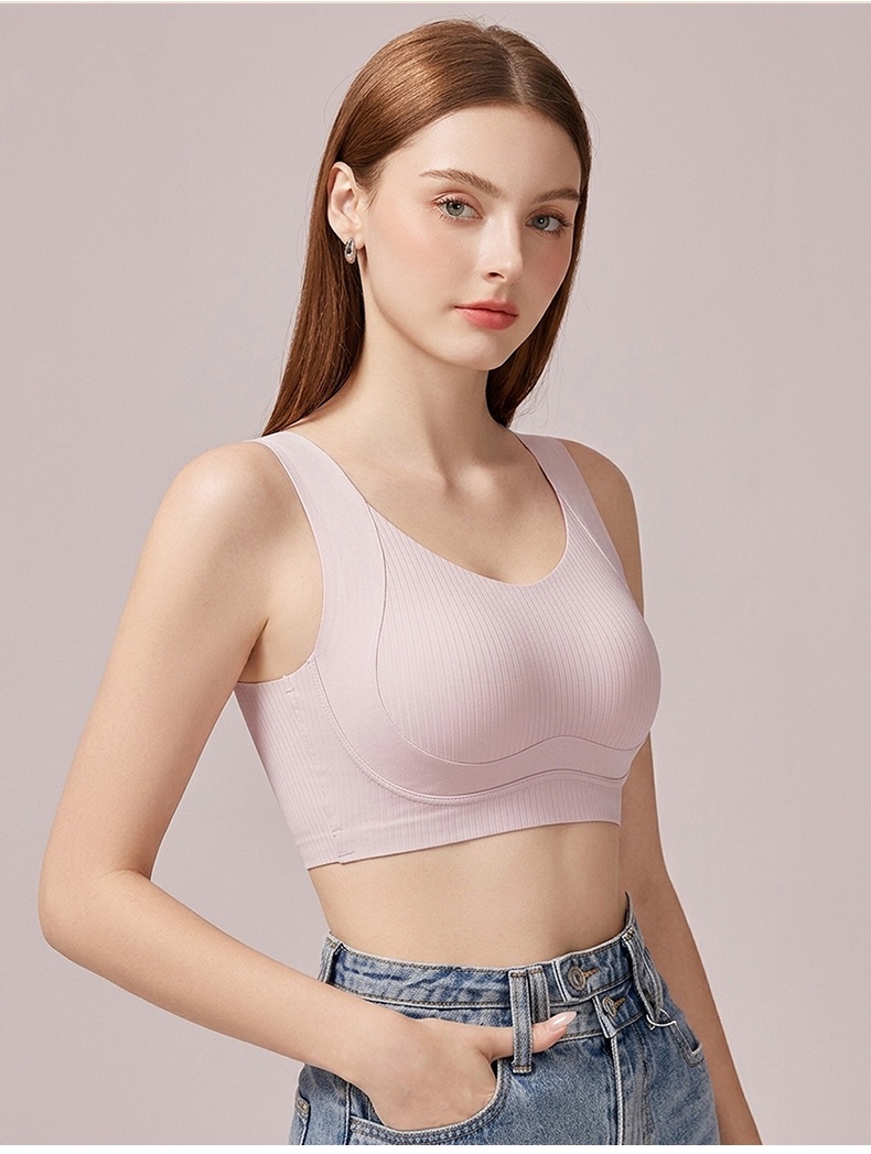 Model wearing pink seamless bra in three-quarter front view VEIMIA