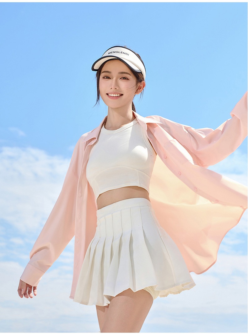 Model wearing pink UV sun protection jacket with white pleated skirt outdoors - VEIMIA