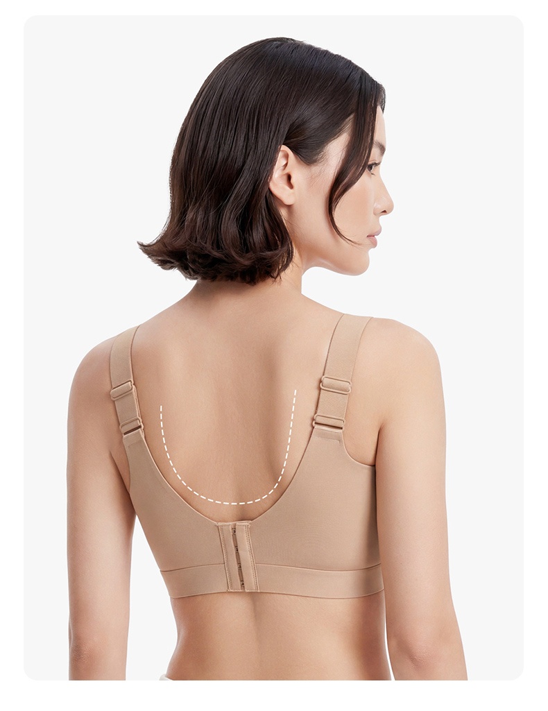 Back view of model wearing beige bra with adjustable straps and hook closure VEIMIA