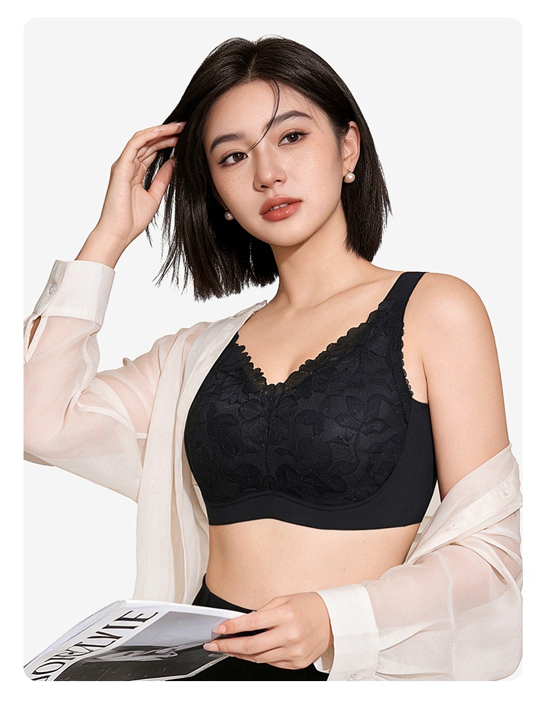 Model wearing black floral lace minimizer bra with wide straps and supportive lace cups - VEIMIA