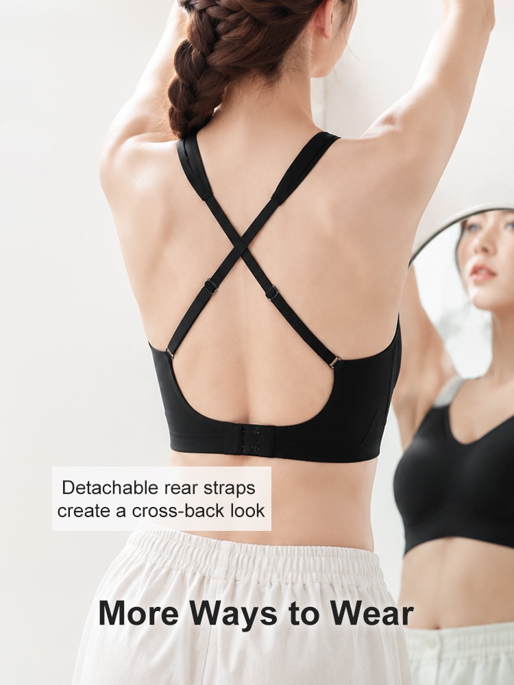 Back view of model wearing black bra with detachable cross straps VEIMIA