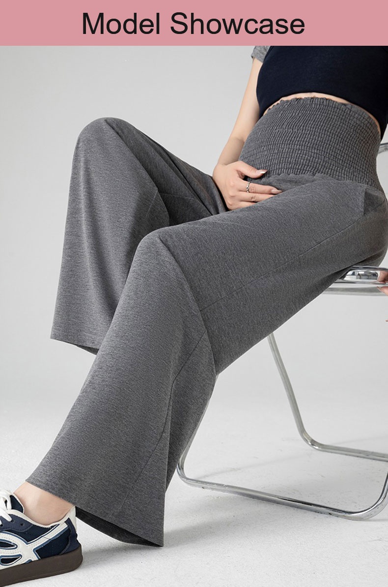 Seated model wearing gray wide-leg maternity pants with high stretch waist VEIMIA