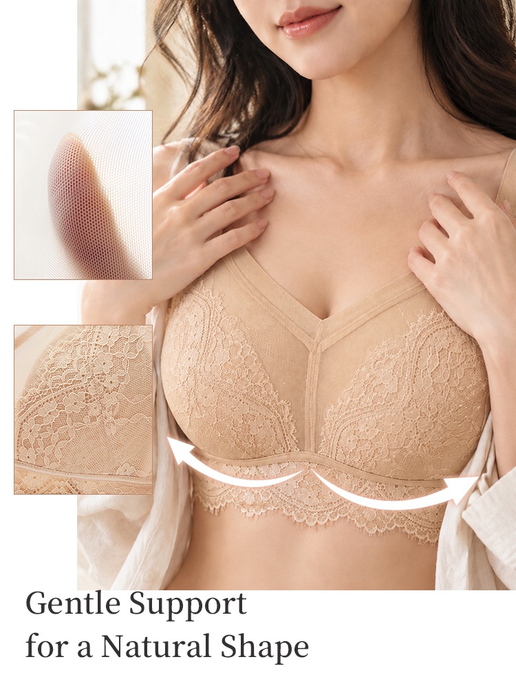 Model wearing beige floral lace bra with support arrows and fabric detail insets VEIMIA
