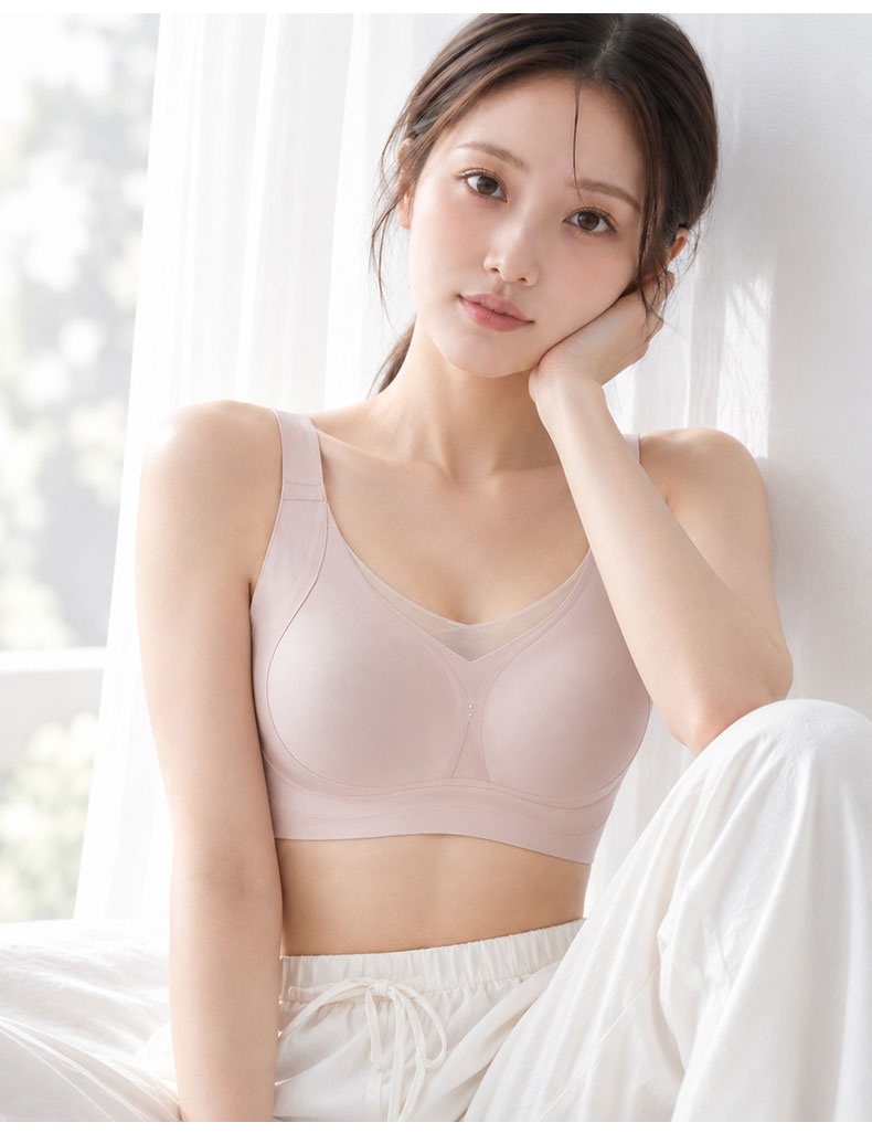 Model wearing light purple wireless bra in seated front view VEIMIA