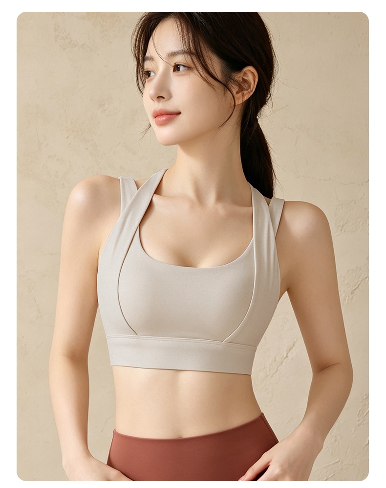 Model wearing gray high impact sports bra front view VEIMIA
