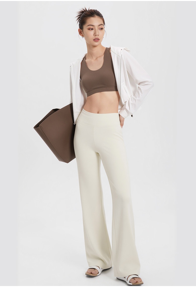 Model wearing white straight-cut pants with sporty casual styling VEIMIA