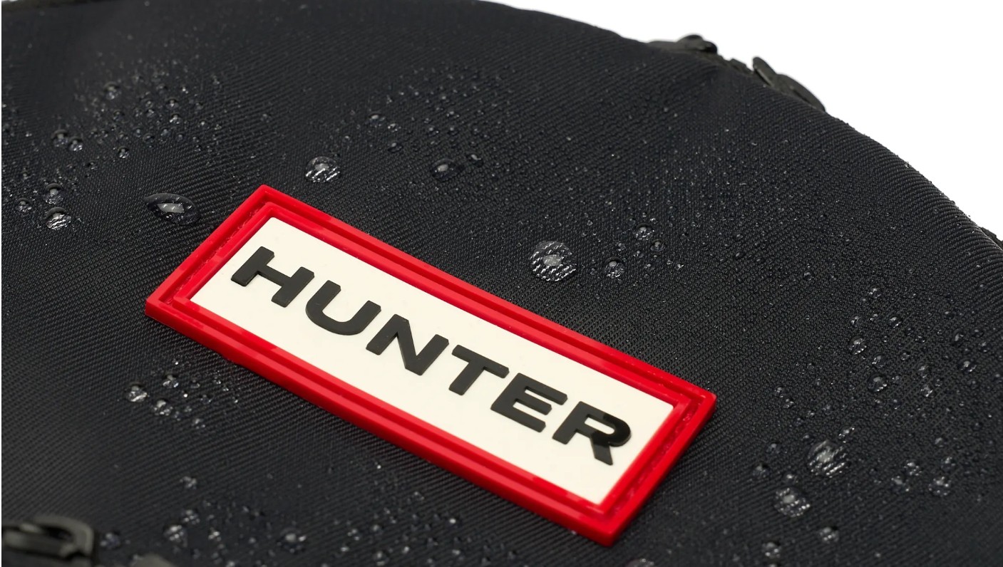 Close-up of a Hunter logo on a water-resistant nylon bag Singapore shoppers can choose for sustainable style.