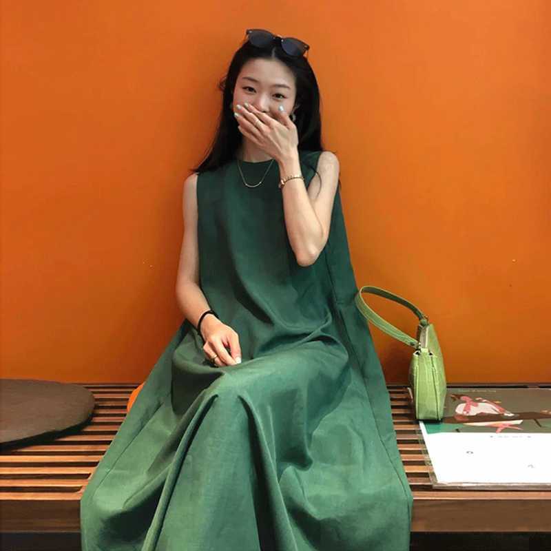 墨綠鬆身A字長裙｜及踝大口袋 × 後背交叉繫帶背心裙