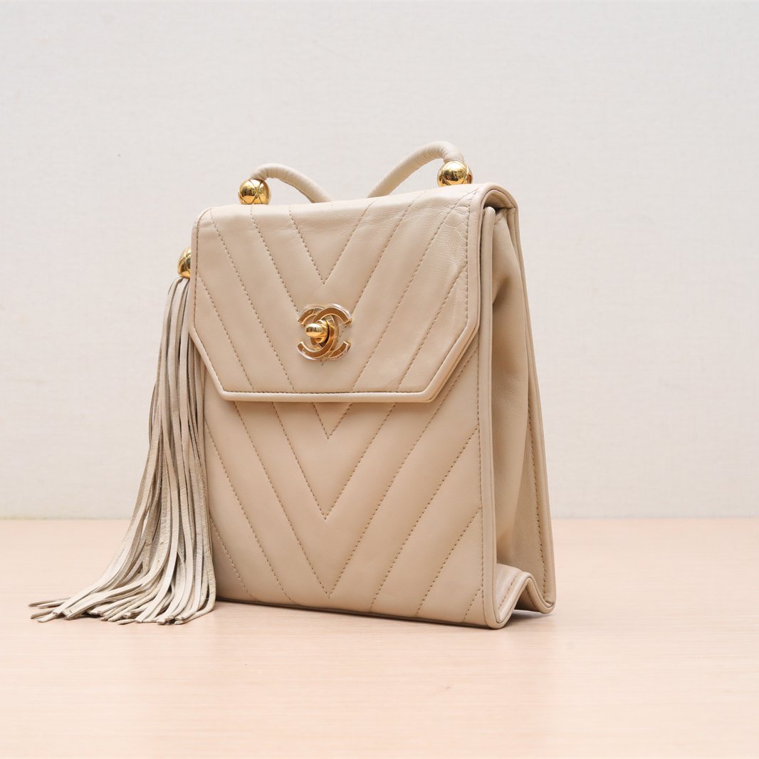 *CHANEL Vintage Beige and Gold Sheepskin Fringe and Gold Ball Crossbody Bag, Off-white, 1991, Beige, , 1991, Gold Hardware-Hana Vintage