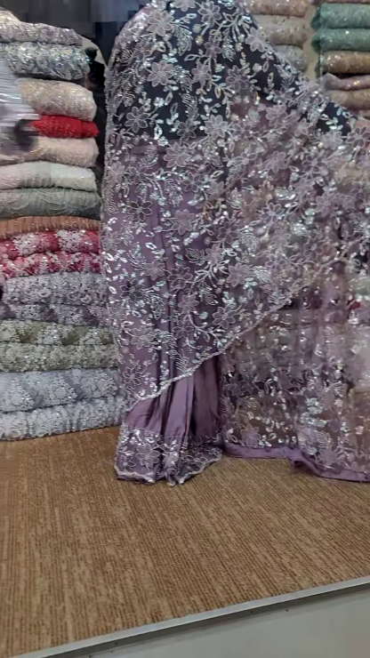 Elegant Purple Net Saree with Intricate Design