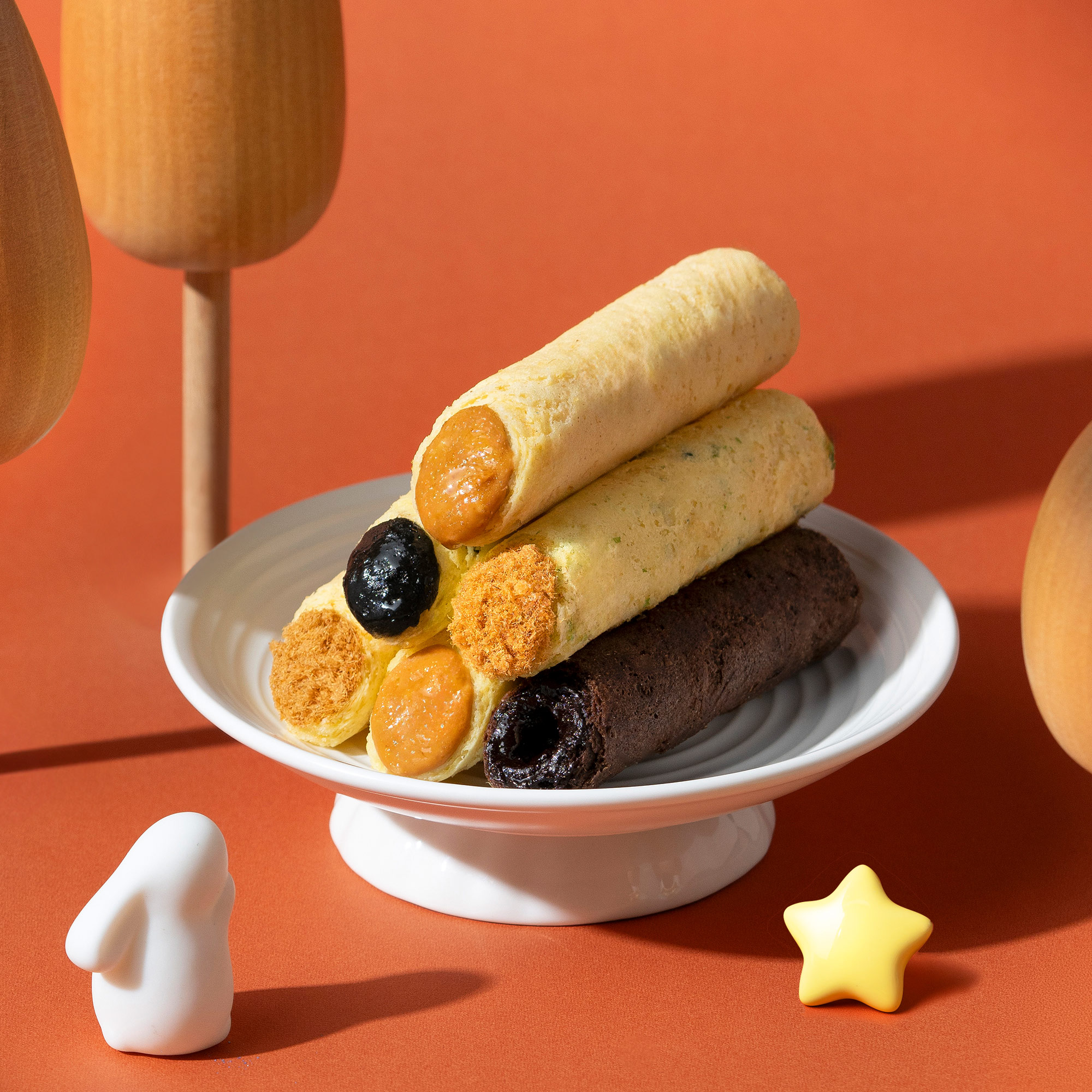 Four classic filled egg roll flavours served on a white plate.