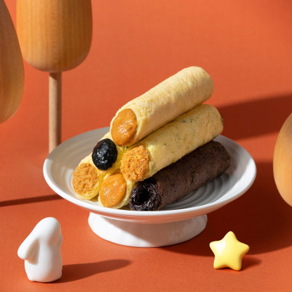 Four classic filled egg roll flavours served on a white plate.