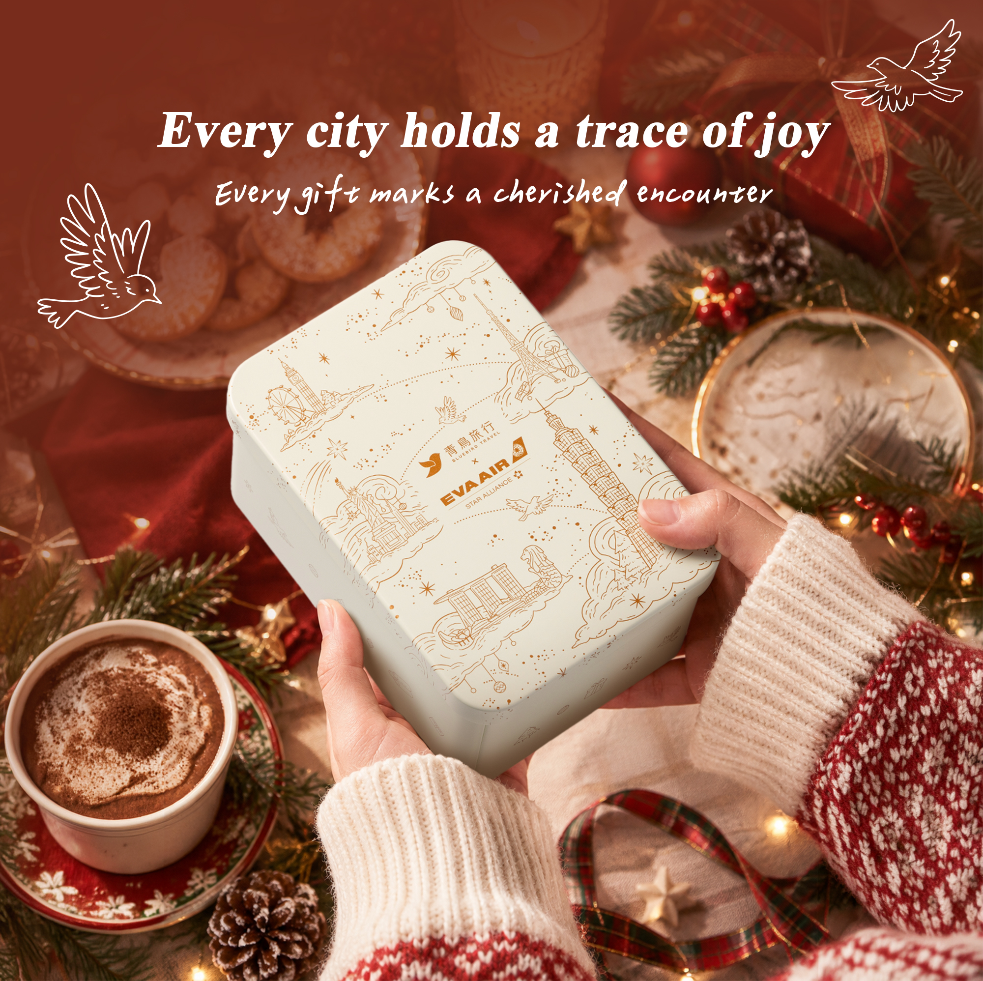 Bluebird Travel x EVA Air Christmas Journey Gift Box held in a festive Christmas setting.