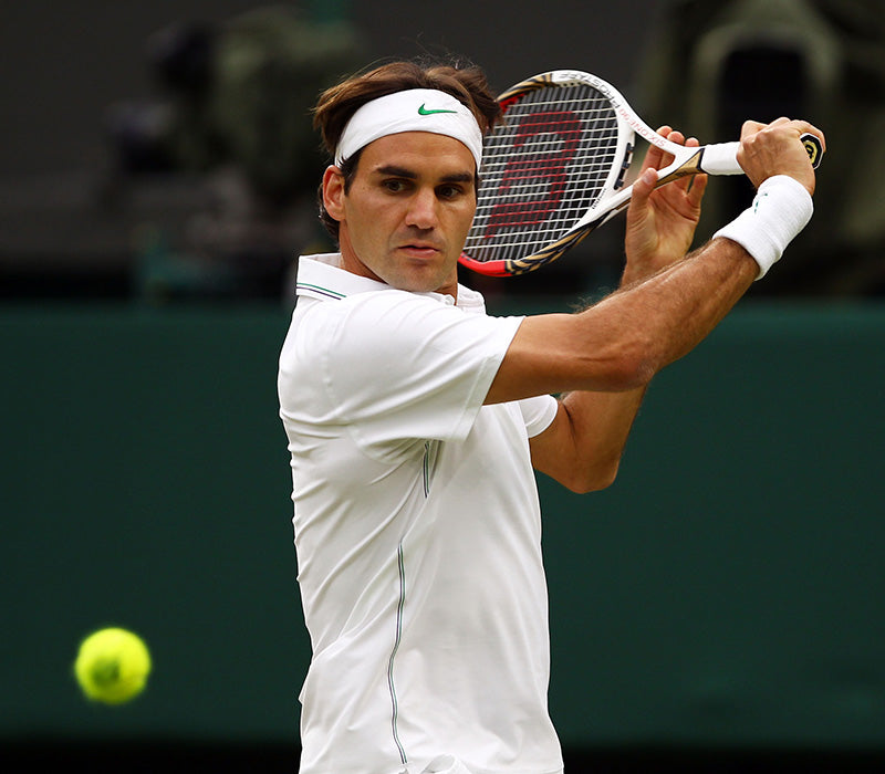 Roger Federer, earlier in his career, mid game about to hit a ball