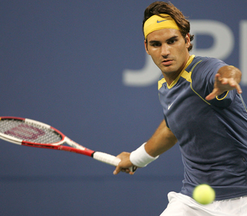 Roger Federer, earlier in his career, mid game about to hit a ball