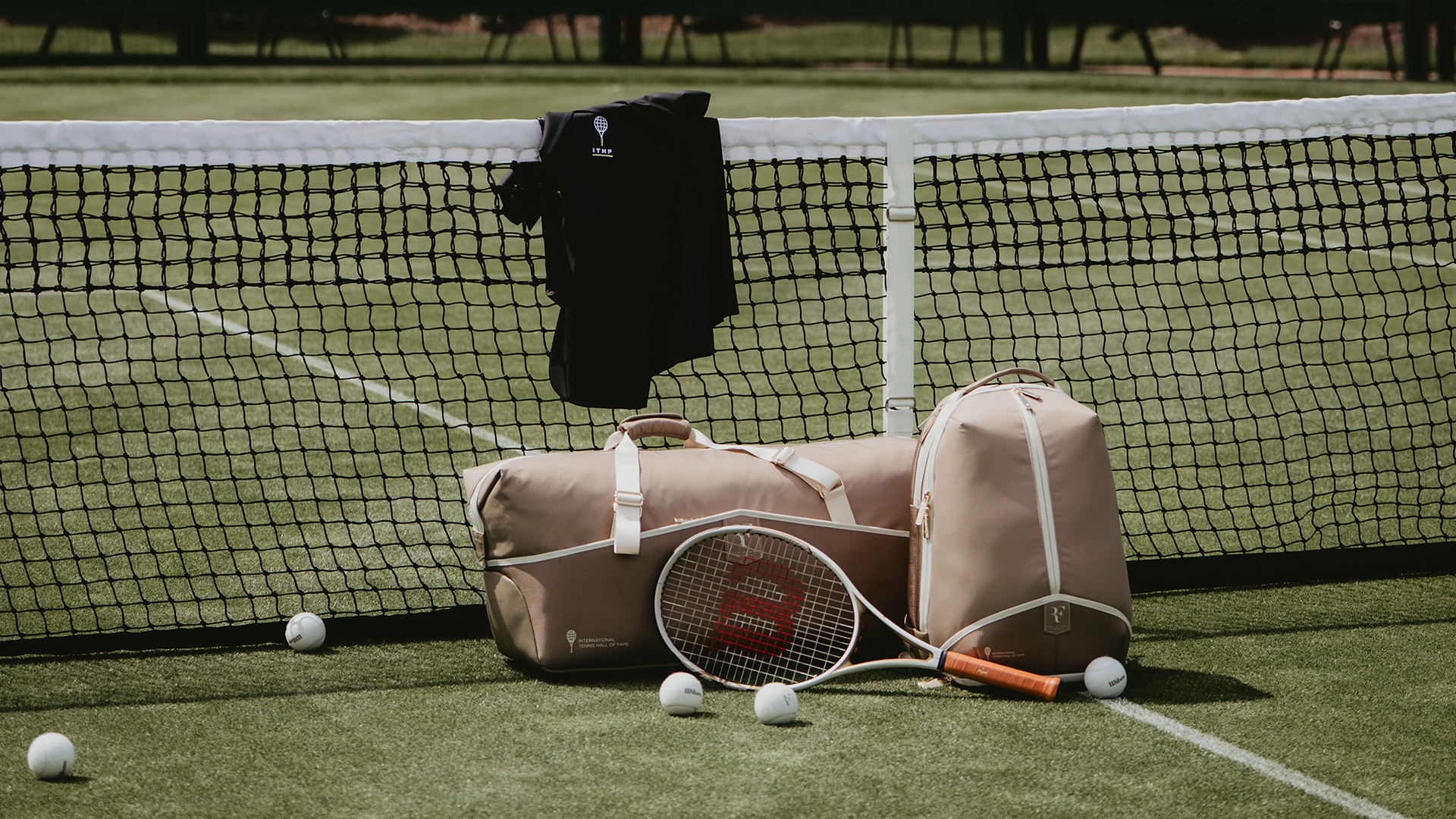 Wilson RF Hall of Fame racket and tennis bags displayed on court