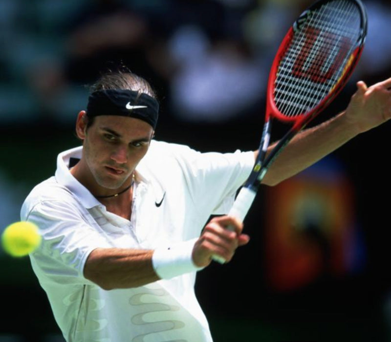 Roger Federer, earlier in his career, mid game about to hit a ball